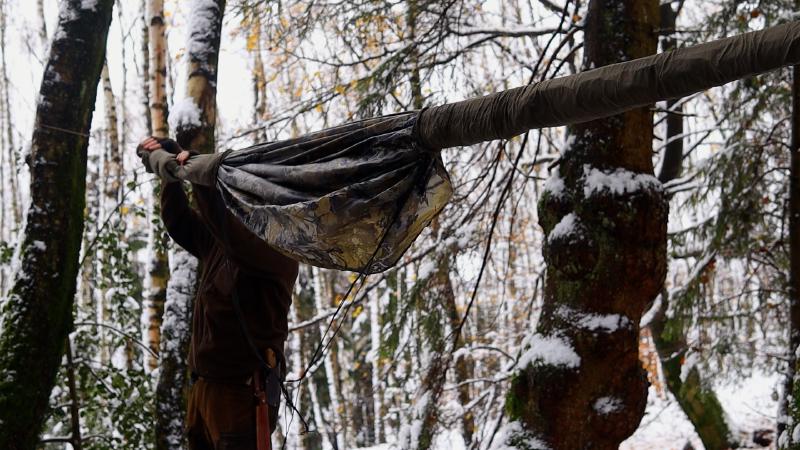 The hammock being attached and adjusted on a tree